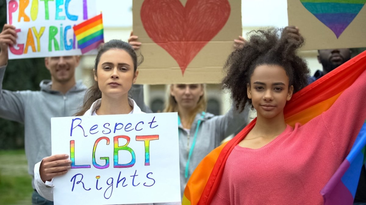 Group,Of,People,Raising,Rainbow,Flags,,Posters,For,Lgbt,Rights,